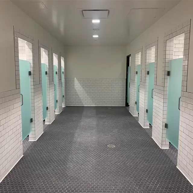 Tile flooring in gym shower stalls